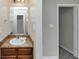 Bright bathroom features a vanity with storage and a large mirror at 1016 Weatherwood Pl, Conyers, GA 30012