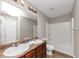 A bathroom featuring dual sinks, a bathtub, and white walls at 1016 Weatherwood Pl, Conyers, GA 30012