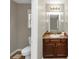 A clean bathroom features a vanity, a toilet, and a large mirror over the sink at 1016 Weatherwood Pl, Conyers, GA 30012