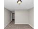 Cozy bedroom featuring gray carpeting, neutral walls, and a bright, airy window at 1016 Weatherwood Pl, Conyers, GA 30012