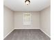 An empty bedroom featuring grey walls, carpet flooring, and a window at 1016 Weatherwood Pl, Conyers, GA 30012