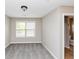 Neutral bedroom features a window for natural light and adjoining bathroom at 1016 Weatherwood Pl, Conyers, GA 30012