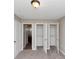 Bedroom featuring an open closet door, bathroom door, and carpeted floors at 1016 Weatherwood Pl, Conyers, GA 30012