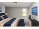 Stylishly decorated bedroom with a plush bed, artwork, and a window for natural light at 1016 Weatherwood Pl, Conyers, GA 30012