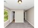A cozy bedroom with plush gray carpeting, a neutral color palette and a bright window at 1016 Weatherwood Pl, Conyers, GA 30012