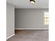 Bedroom featuring a window and gray walls, with soft carpeting for comfort at 1016 Weatherwood Pl, Conyers, GA 30012