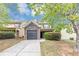 Inviting townhome boasts stone accents, mature trees, an attached garage, and well-manicured landscaping at 1016 Weatherwood Pl, Conyers, GA 30012