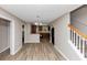 Open-concept kitchen boasts black appliances, wood-look flooring, and a breakfast bar at 1016 Weatherwood Pl, Conyers, GA 30012