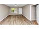 A bright room boasts modern flooring, neutral walls, and a convenient entry door at 1016 Weatherwood Pl, Conyers, GA 30012