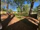Landscaped backyard featuring green grass, mature trees, mulch, and a wood fence at 1929 Hazelwood Se Dr, Marietta, GA 30067