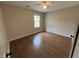 Bedroom showcasing hardwood floors, neutral walls, and natural light from a window at 1929 Hazelwood Se Dr, Marietta, GA 30067