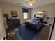 Cozy bedroom with blue accents, a wooden bed frame, and fun automotive and skateboard decor at 1929 Hazelwood Se Dr, Marietta, GA 30067