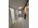 Hallway features tile flooring, a window, and access to a bathroom via barn door and walk-in closet at 1929 Hazelwood Se Dr, Marietta, GA 30067