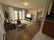 Bright living room with hardwood floors, neutral paint, french doors, and access to a kitchen bar at 1929 Hazelwood Se Dr, Marietta, GA 30067