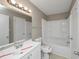 Bathroom with a shower/tub combo, white tiled walls, and a modern vanity at 2458 Haverford Way, Decatur, GA 30032