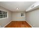 Empty bedroom features hardwood floors and two windows for natural light at 2458 Haverford Way, Decatur, GA 30032