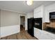 Kitchen featuring tile backsplash, appliances, and access to living area at 2458 Haverford Way, Decatur, GA 30032
