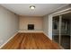 A spacious living room offers a cozy fireplace and sliding glass doors to the exterior at 2458 Haverford Way, Decatur, GA 30032