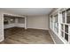 Open-concept living area featuring wood-look floors and large windows at 2458 Haverford Way, Decatur, GA 30032