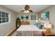 Stylishly staged main bedroom with hardwood floors, furniture, and neutral paint at 2458 Haverford Way, Decatur, GA 30032