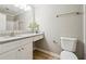 Well-lit bathroom with granite countertops, sink, mirror, toilet and vanity at 20 Trace Ct, Covington, GA 30016