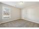 Neutral bedroom with carpet, a window for natural light, and a door to the hallway at 20 Trace Ct, Covington, GA 30016