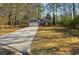 Front exterior of a red brick home with a long driveway leading to an attached two-car garage at 20 Trace Ct, Covington, GA 30016