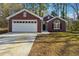 Charming brick home featuring an attached garage, traditional curb appeal, and a well-kept lawn at 20 Trace Ct, Covington, GA 30016