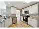 Beautiful kitchen with white cabinets, stainless steel appliances, and granite counters at 20 Trace Ct, Covington, GA 30016