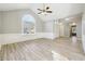 Bright living room with a vaulted ceiling and arched window, leading to the foyer at 20 Trace Ct, Covington, GA 30016