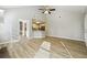 Open-concept living area with wood floors connects kitchen and dining area at 20 Trace Ct, Covington, GA 30016