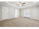 Large bedroom featuring trey ceiling, ceiling fan, carpet and ensuite bathroom at 20 Trace Ct, Covington, GA 30016