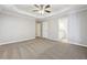 Large bedroom with access to bathroom, trey ceiling and neutral colored walls at 20 Trace Ct, Covington, GA 30016