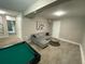 Finished basement area featuring a pool table, comfortable seating, and neutral decor at 4064 Chimney Ridge Way, Ellenwood, GA 30294