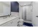Bright bathroom with updated vanity, shower with tile surround, and coordinating floor tile at 4064 Chimney Ridge Way, Ellenwood, GA 30294