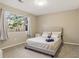 Bright bedroom showcasing a large window, neutral decor, and plush carpeting at 4064 Chimney Ridge Way, Ellenwood, GA 30294