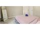Neutral bedroom featuring a platform bed, mirror, and view into the hallway at 4064 Chimney Ridge Way, Ellenwood, GA 30294