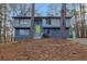Charming split-level home with a bright green door and a landscaped front yard at 4064 Chimney Ridge Way, Ellenwood, GA 30294