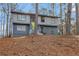 Charming two-story home with gray siding, a bright yellow door, and a well-maintained front yard at 4064 Chimney Ridge Way, Ellenwood, GA 30294