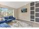 Cozy living room featuring comfortable blue sofas and a scenic view from the large window at 4064 Chimney Ridge Way, Ellenwood, GA 30294