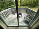 Private balcony featuring outdoor seating and views of the surrounding greenery at 4064 Chimney Ridge Way, Ellenwood, GA 30294