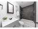 Modern bathroom with grey tile, white vanity, and bathtub at 7771 Mattie Mccoy Ln, Winston, GA 30187