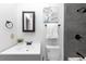 Clean bathroom with dark grey tile and updated vanity at 7771 Mattie Mccoy Ln, Winston, GA 30187
