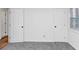 Bright bedroom with grey carpet and two doors at 7771 Mattie Mccoy Ln, Winston, GA 30187