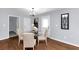 Bright dining room with hardwood floors and glass table at 7771 Mattie Mccoy Ln, Winston, GA 30187