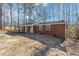 Side view of brick ranch house with yard at 7771 Mattie Mccoy Ln, Winston, GA 30187