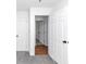 Clean hallway with hardwood floors and white doors at 7771 Mattie Mccoy Ln, Winston, GA 30187