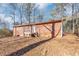 Brick house exterior with wooden deck and surrounding trees at 7771 Mattie Mccoy Ln, Winston, GA 30187