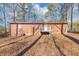 Brick house exterior with wooden deck and surrounding trees at 7771 Mattie Mccoy Ln, Winston, GA 30187