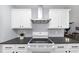 White kitchen cabinets and a glass top stove at 7771 Mattie Mccoy Ln, Winston, GA 30187